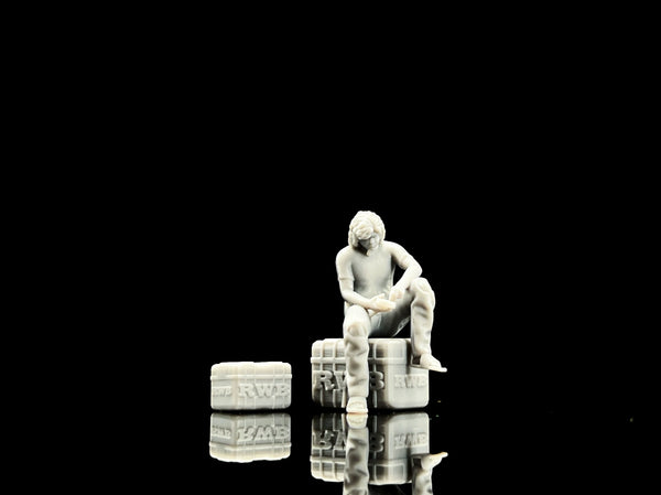 Unpainted 1:64 seated garage figure with tires