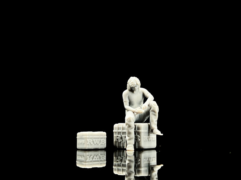 Unpainted 1:64 seated garage figure with tires